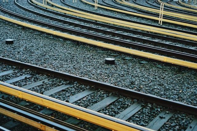 Close-up of curved rail tracks showing railway infrastructure.